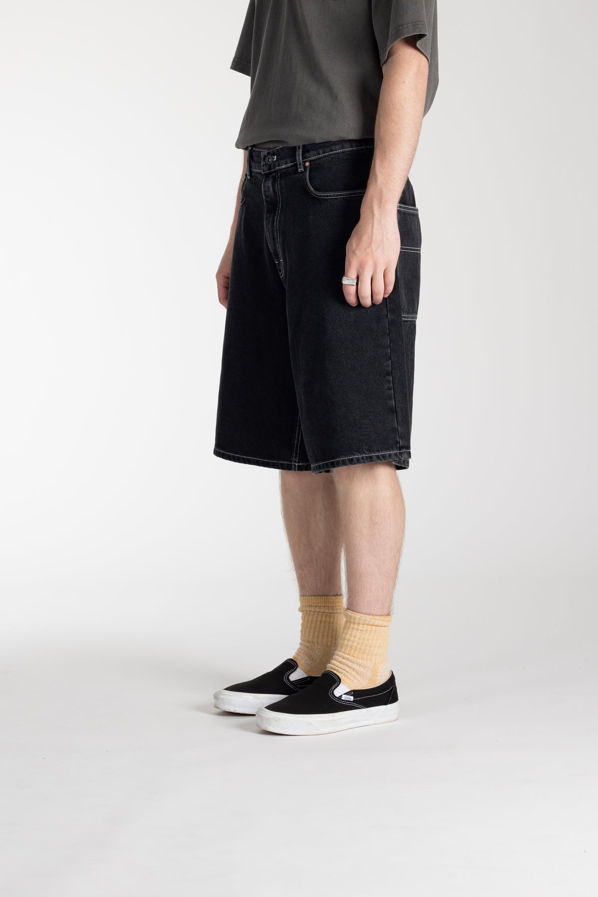 Side view of model wearing Stan Ray Wide 5 Short in Washed Black