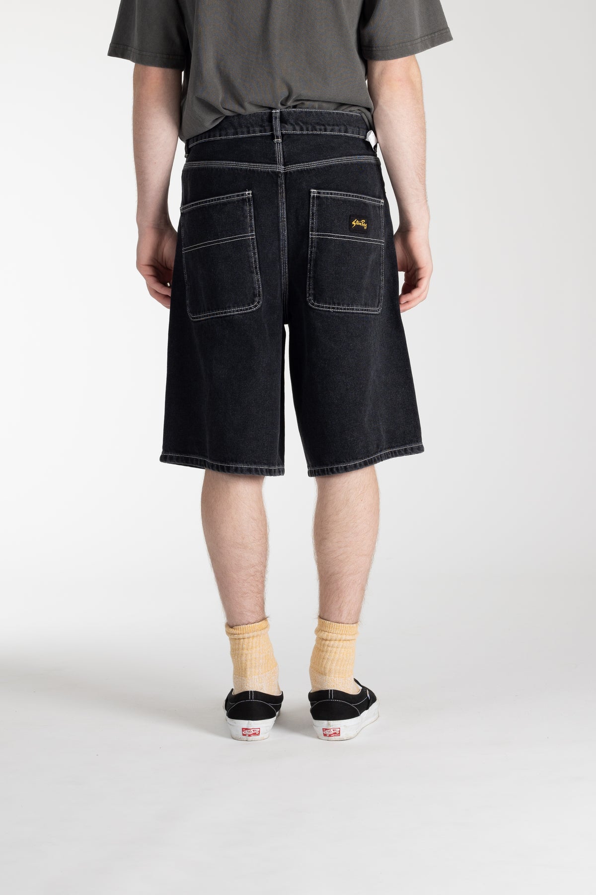 Rear view of model wearing Stan Ray Wide 5 Short in Washed Black