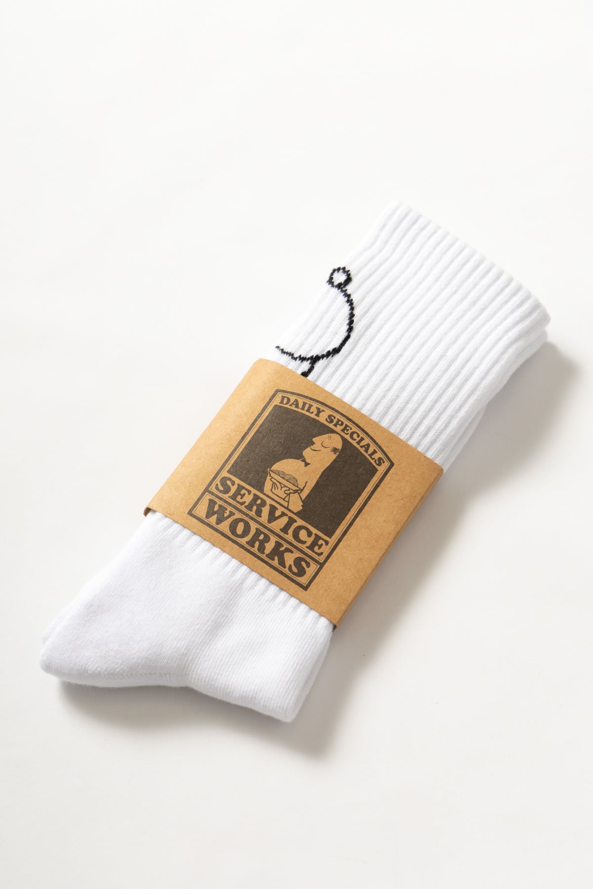 White crew socks with salt and pepper graphic worn on feet, showing fit and everyday styling detail