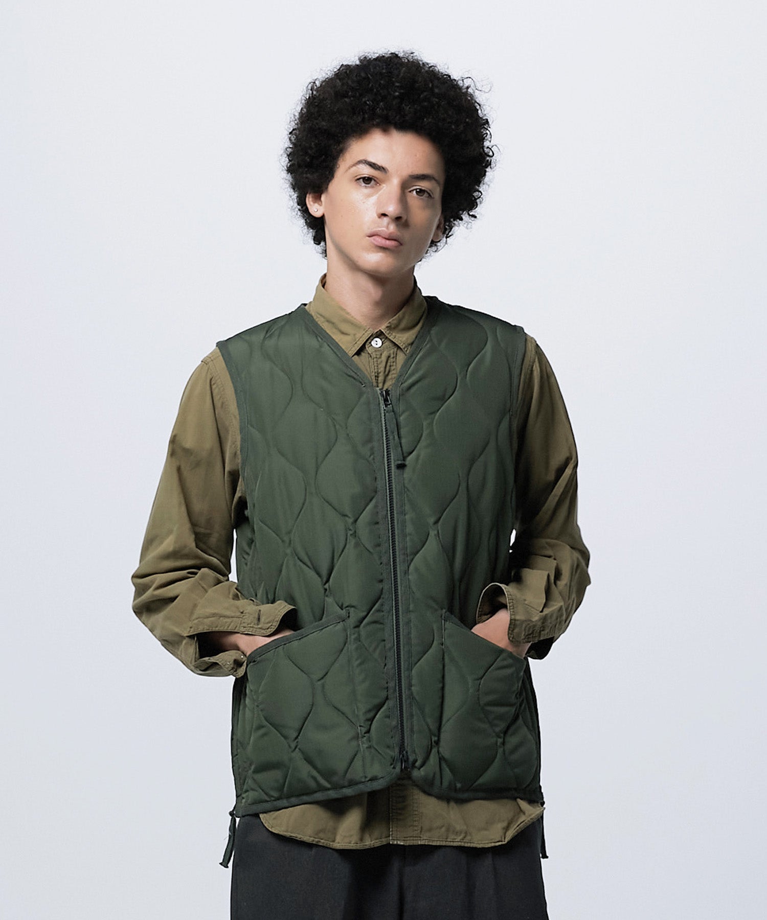 Model wearing TAION Unisex Military W-Zip V-Neck Down Vest in Olive