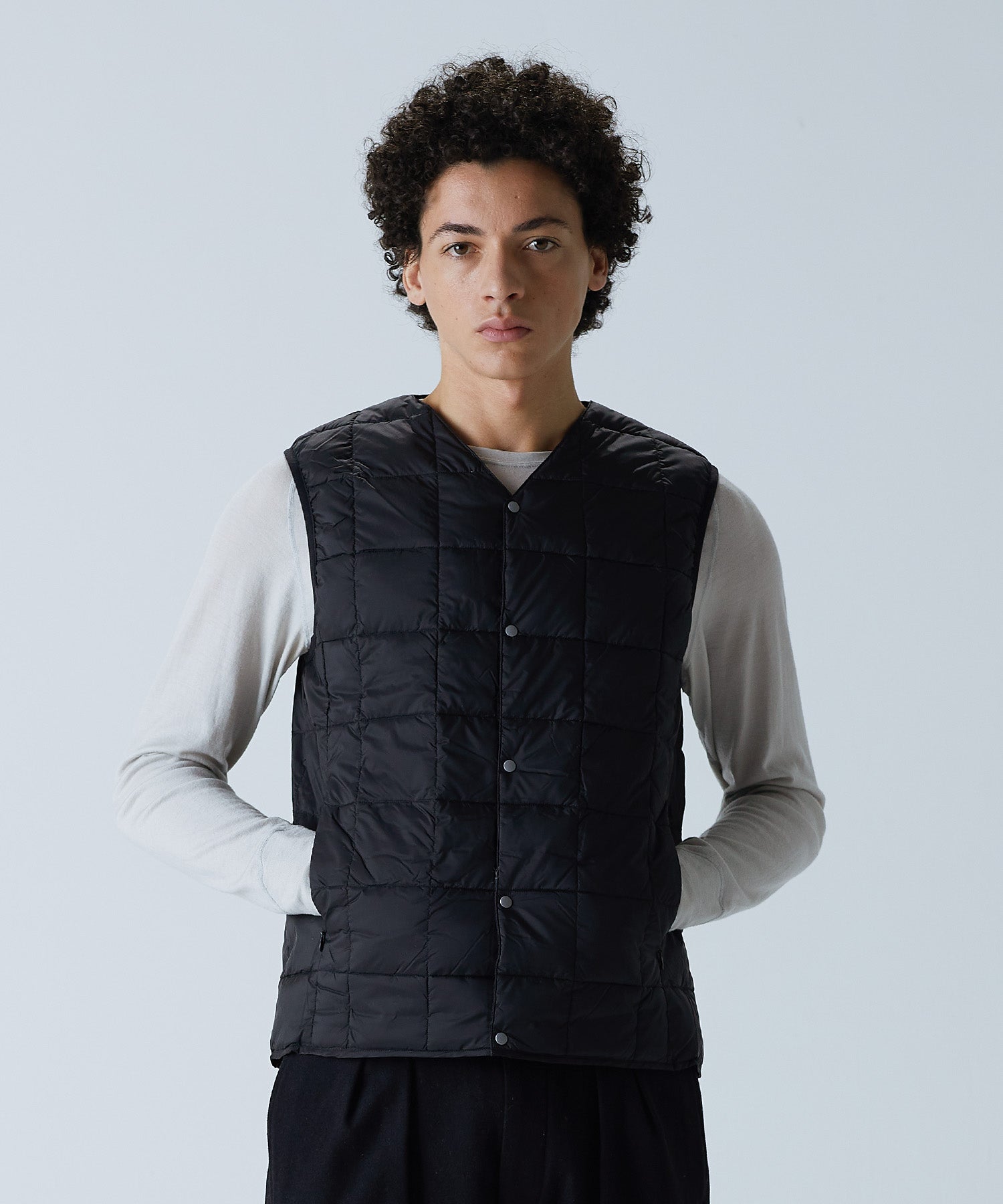 TAION Men's V-Neck Button Down Down Vest in Black worn by model