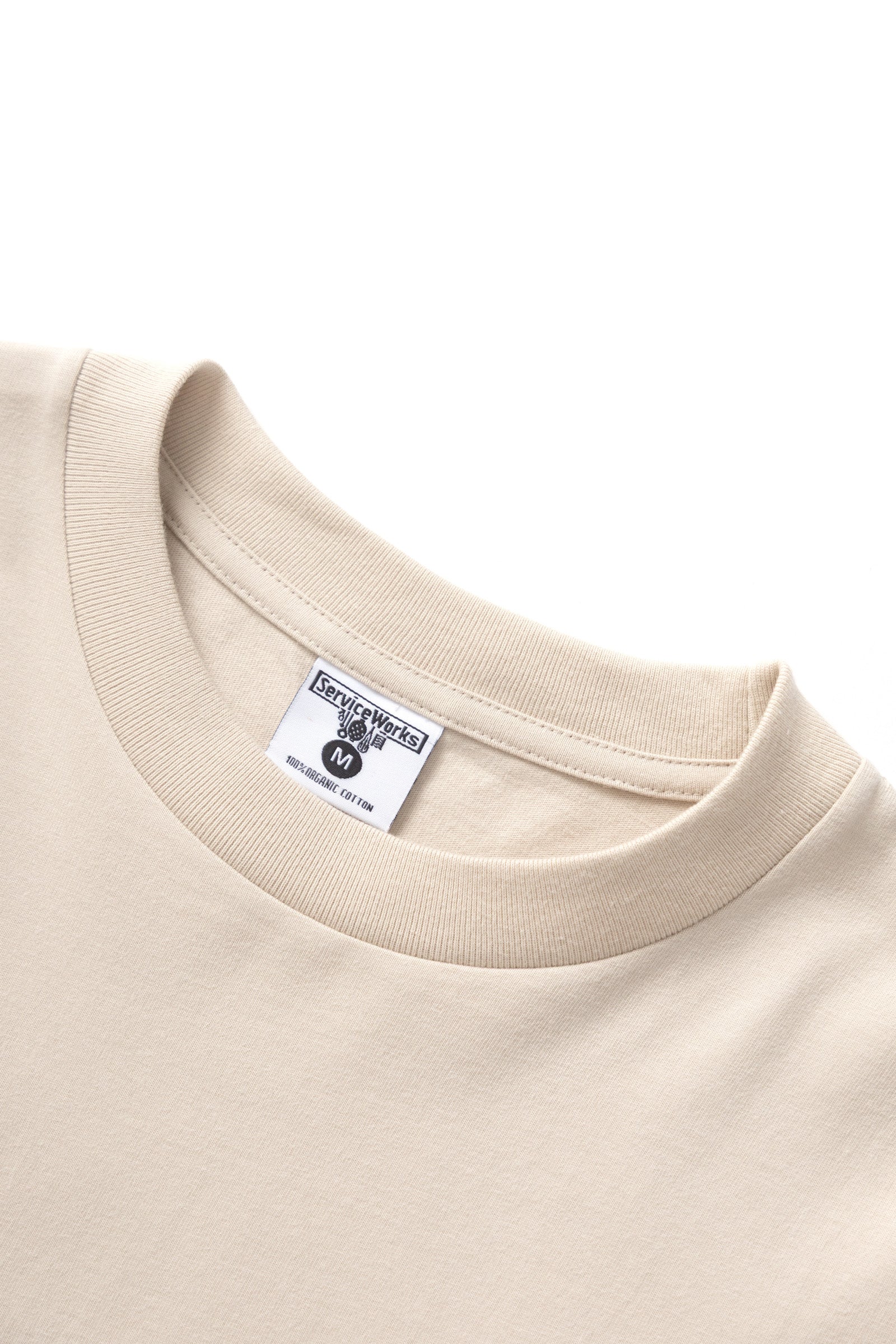Natural cotton bootleg long sleeve tee front detail modern streetwear design relaxed fit