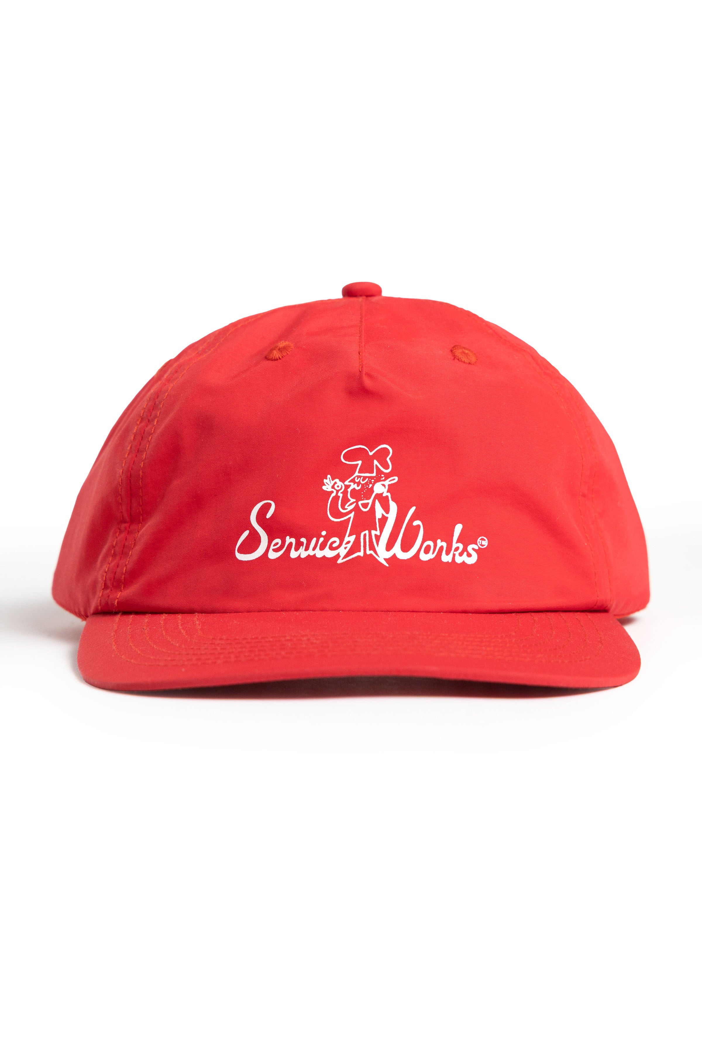 Model wearing red Chefs Kiss Cap shown from side angle, featuring unstructured nylon construction, curved peak brim and relaxed streetwear fit