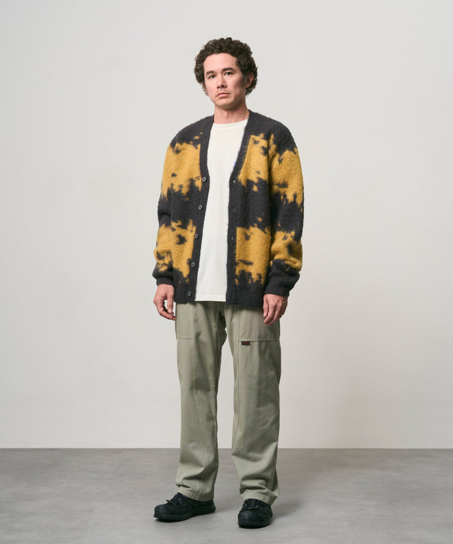 Male model wearing Gramicci Gadget Pant Dried Sage relaxed fit utility climbing pants