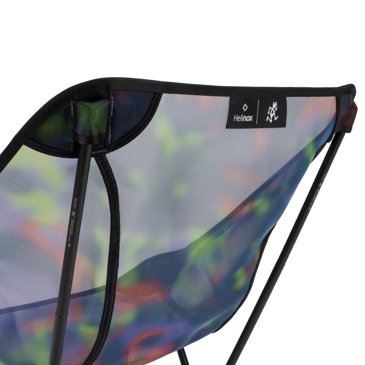 Back view of Gramicci & Helinox Chair One in camo showing lightweight portable frame and tie-dyed mesh fabric design