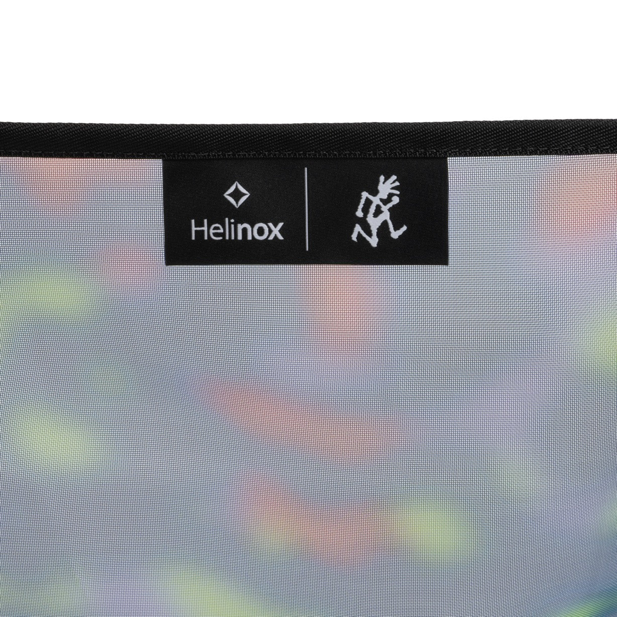 Lifestyle view of Gramicci & Helinox Chair One in camo showing lightweight portable camping chair with tie-dyed mesh fabric design