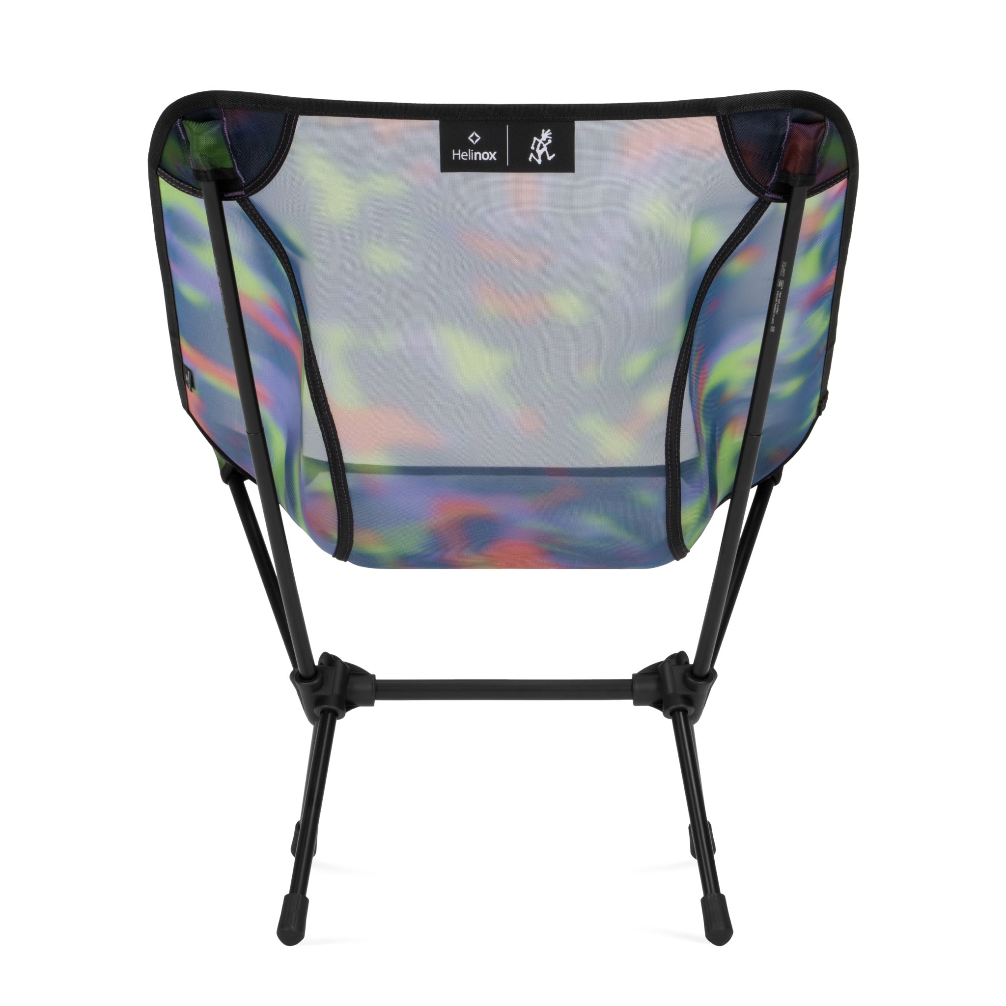 Lifestyle view of Gramicci & Helinox Chair One in camo showing lightweight portable camping chair with tie-dyed mesh fabric design