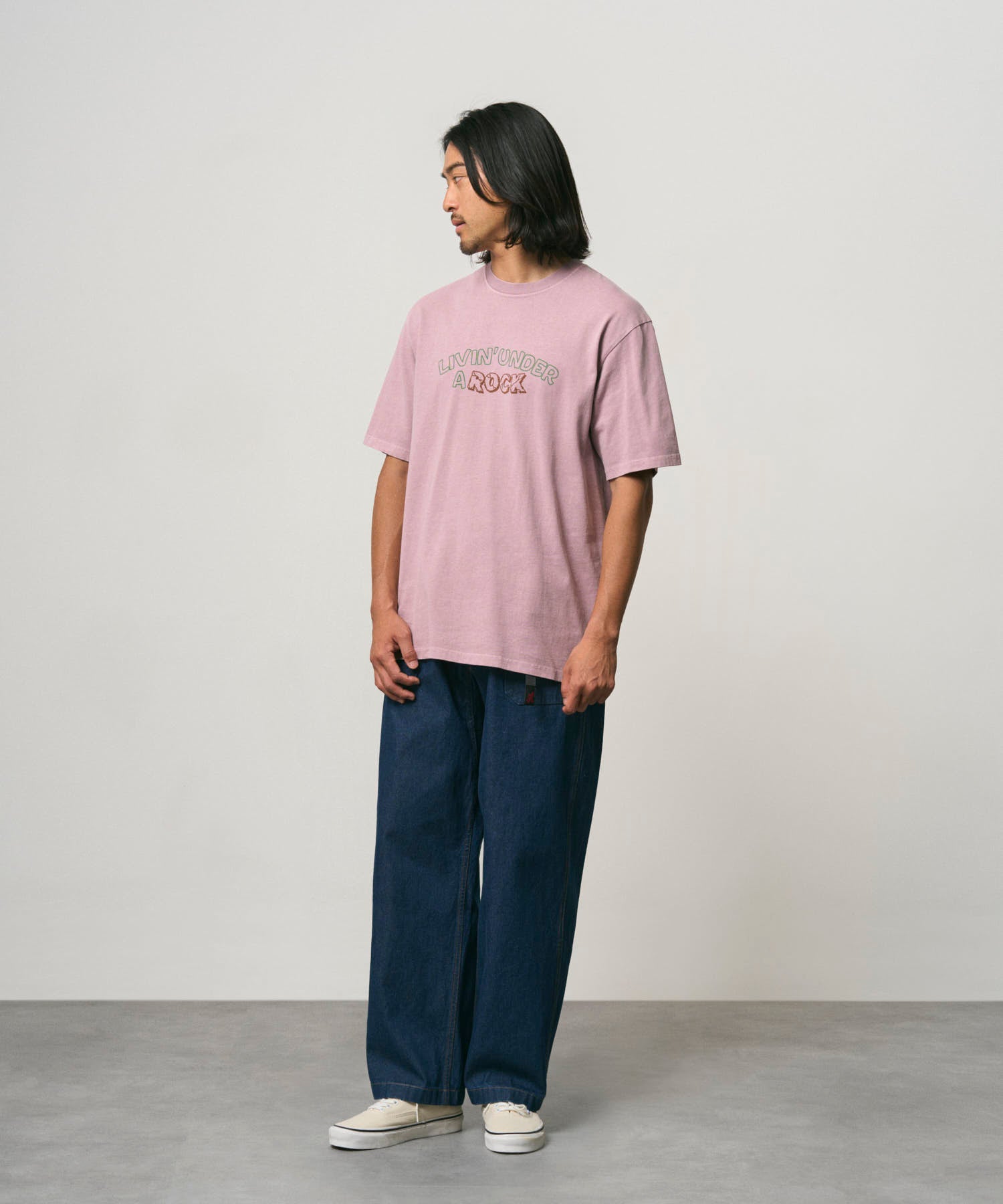 Side view of model wearing Gramicci Livin Tee Lilac Pigment cotton T-shirt