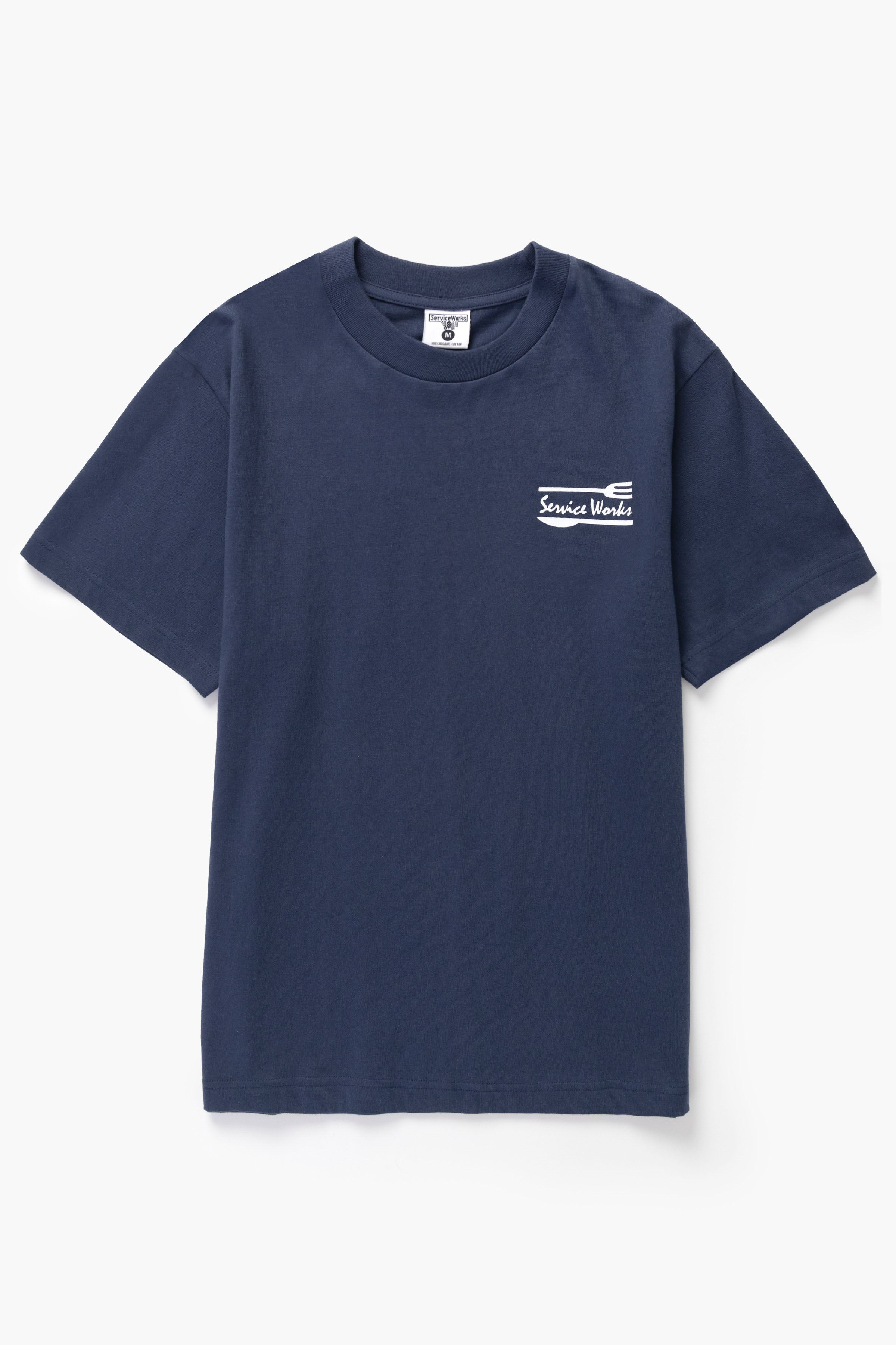 Front view of model wearing navy Milos Tee featuring organic cotton fabric, clean fit and everyday streetwear style