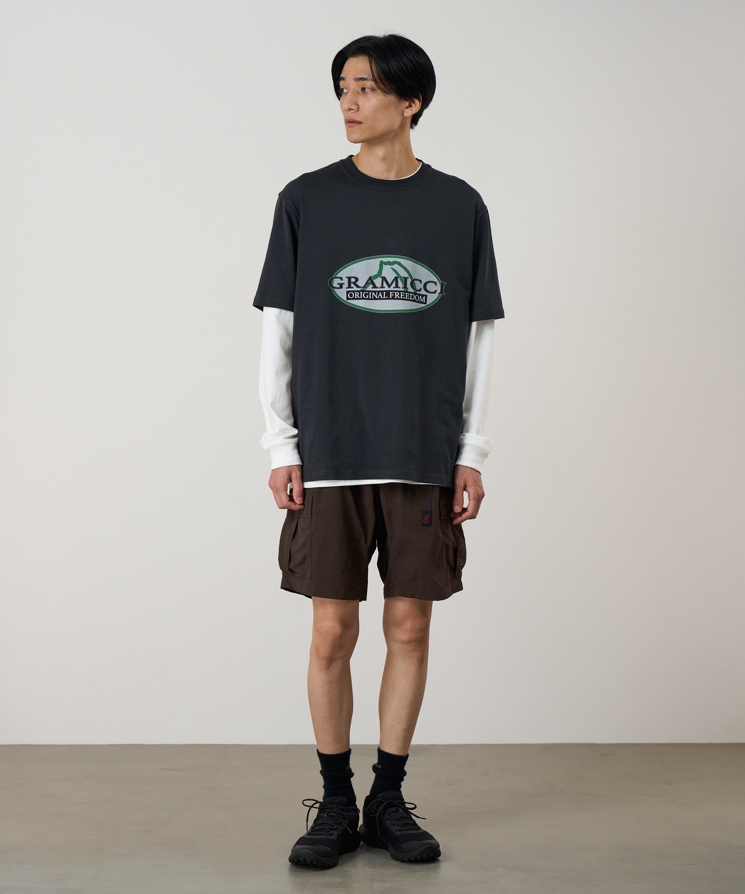 Model wearing Nylon Explorer Cargo Shorts in Chocolate