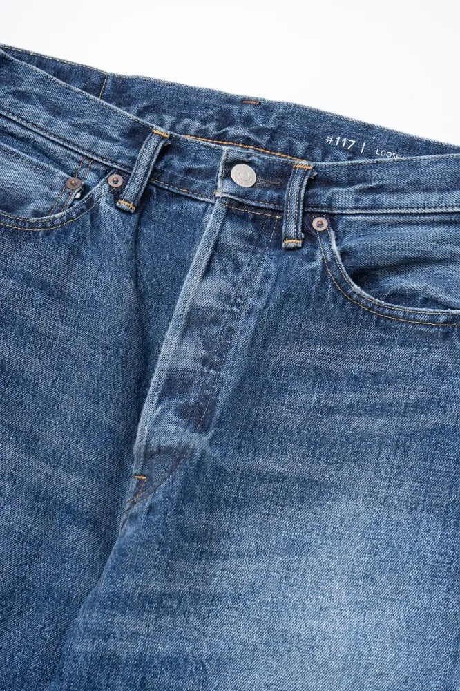 Close-up of Ordinary Fits relaxed fit jeans showing stitching and denim texture
