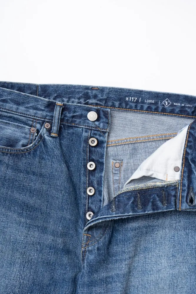 Close-up of Ordinary Fits relaxed fit jeans waistband and button closure detail