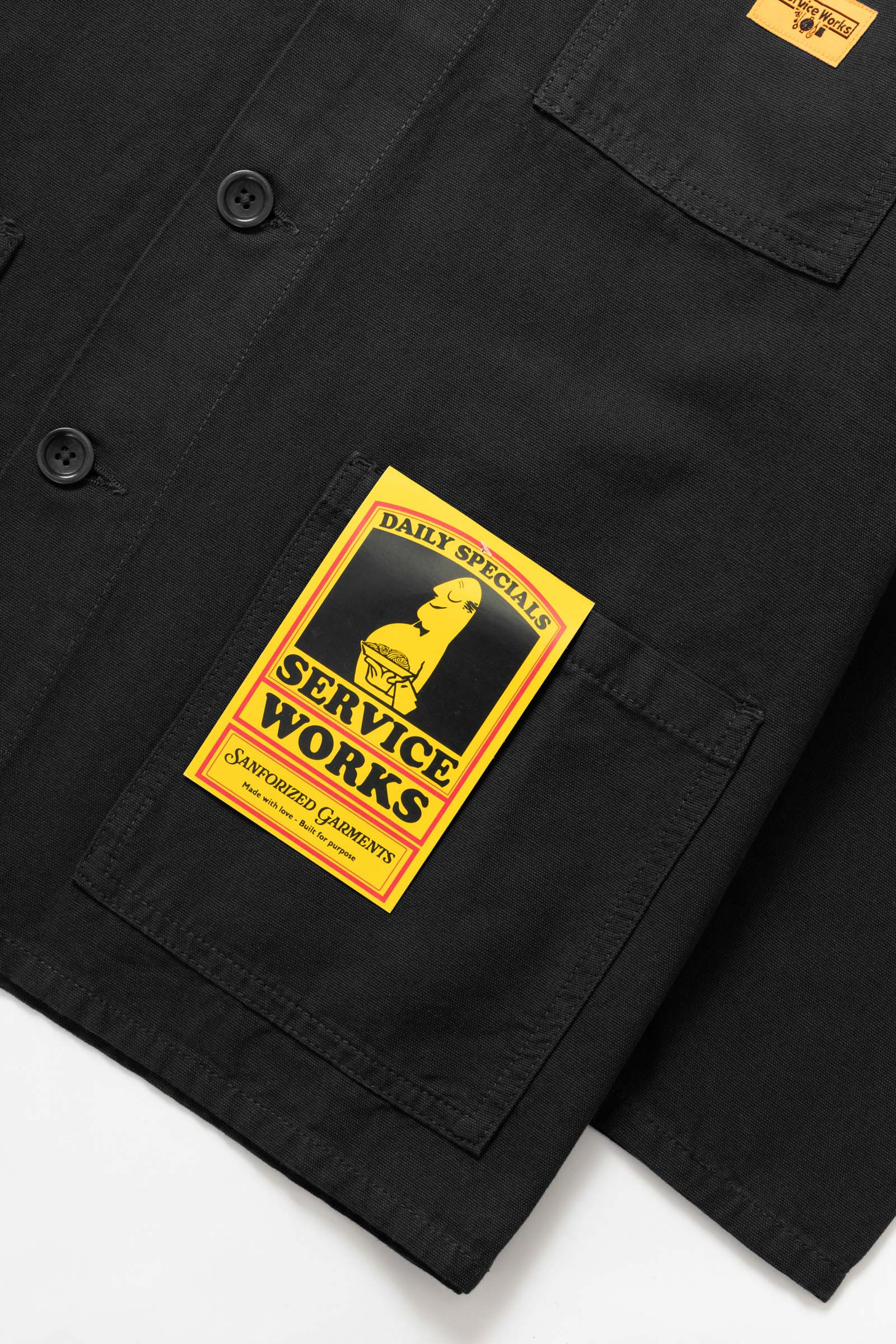 Service Works Canvas Chore Shirt in Black shown from side angle highlighting structured fit and durable workwear canvas fabric.