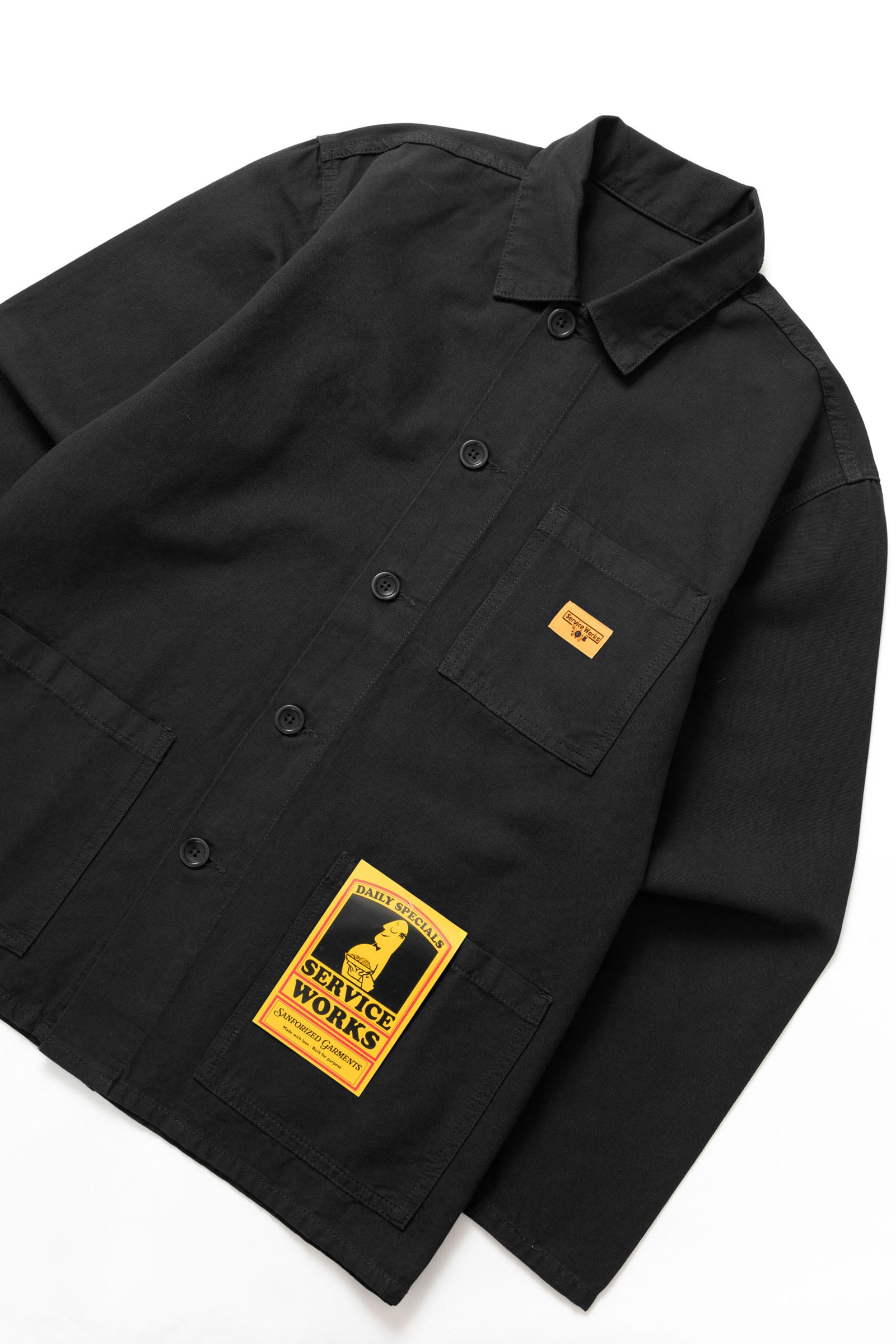 Side view of the Service Works Canvas Chore Shirt in Black showing structured workwear fit and durable canvas construction.