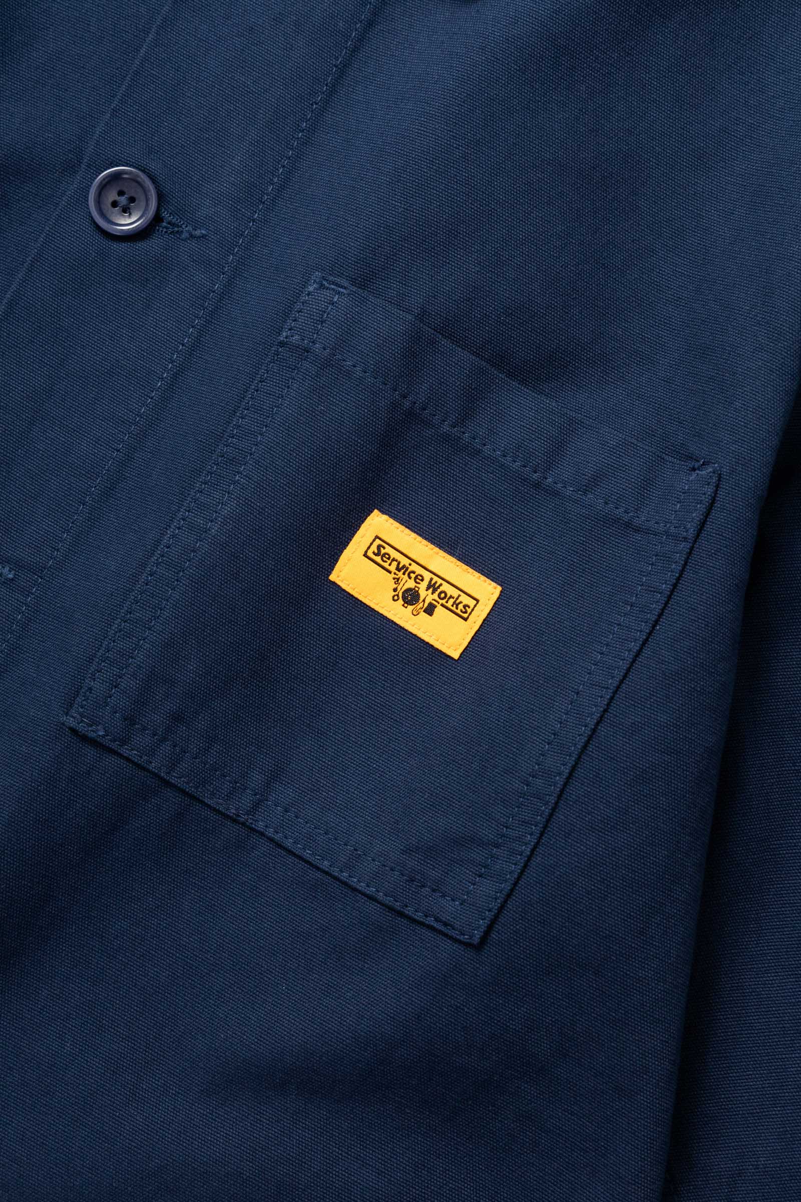 Close-up of the Service Works Canvas Chore Shirt in Navy highlighting chest pocket design and reinforced stitching.