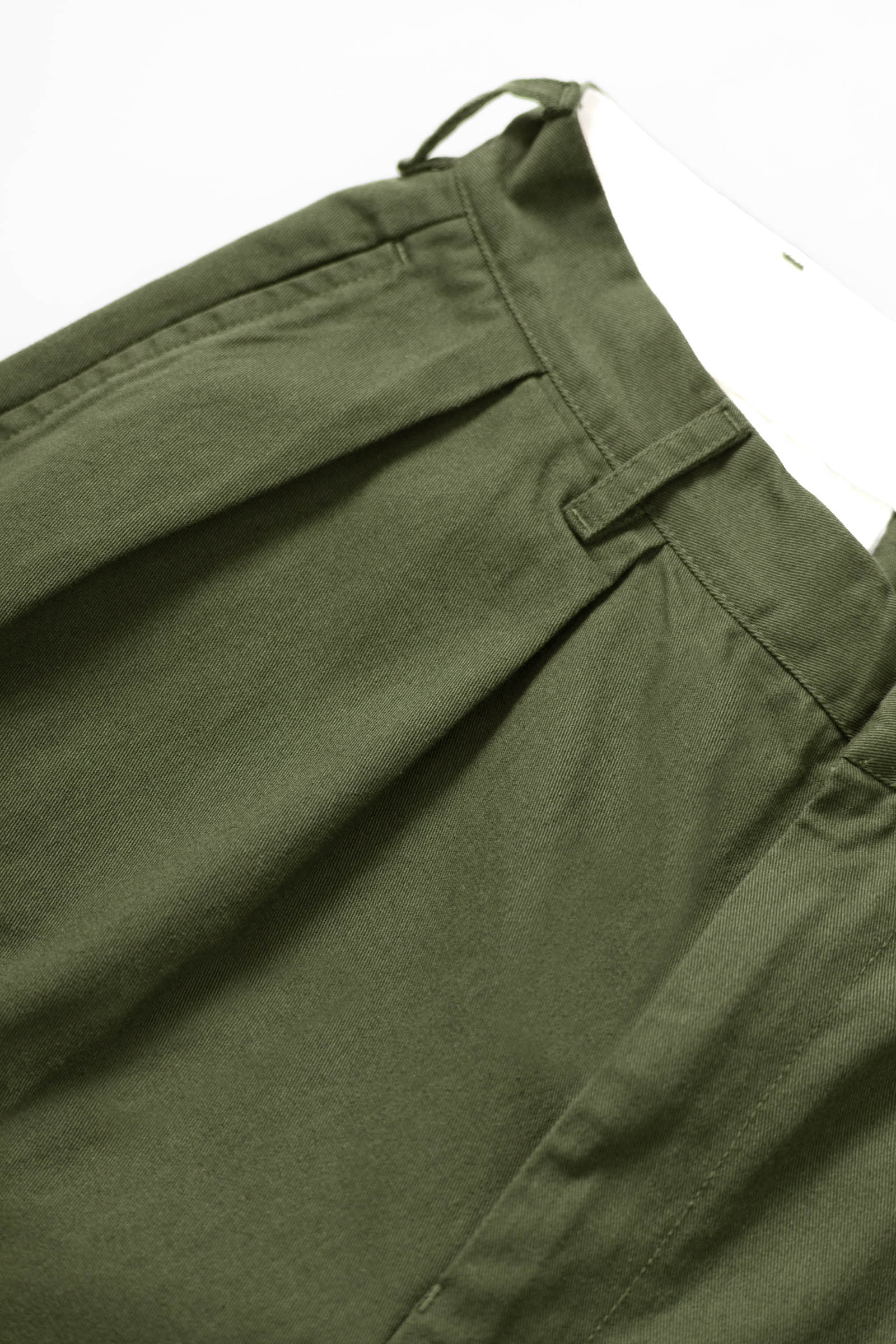 Close-up detail of Service Works Drill Part Timer shorts in olive showing fabric and pleated construction