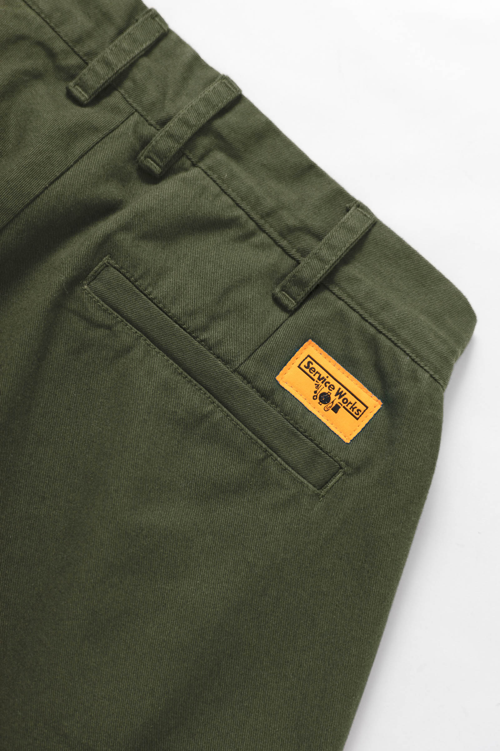 Service Works Drill Part Timer shorts in olive showing branded label detail on workwear shorts