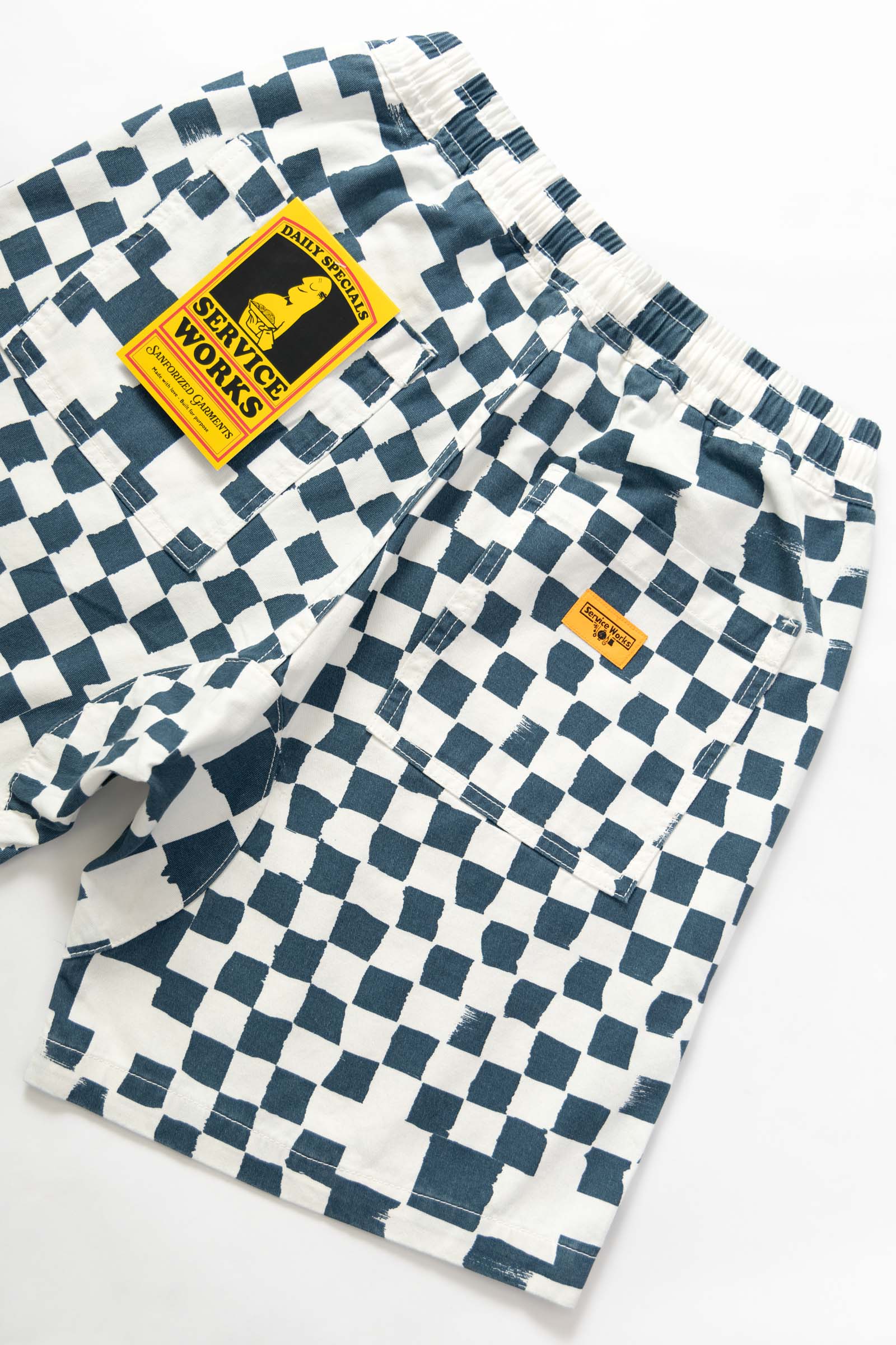 Close-up detail of the Service Works Printed Chef Short in Teal Checker showing fabric texture and reinforced stitching.