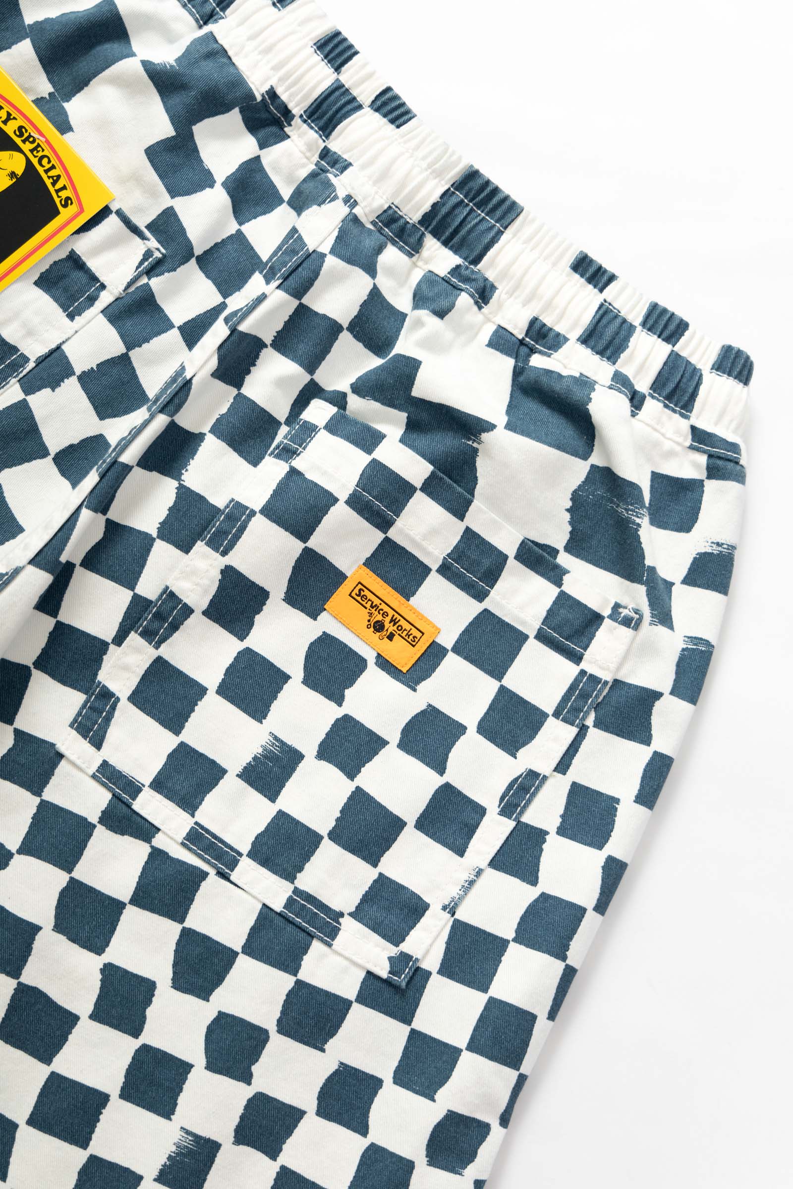 Close-up of the Service Works Printed Chef Short in Teal Checker highlighting fatigue pockets and durable utility construction.