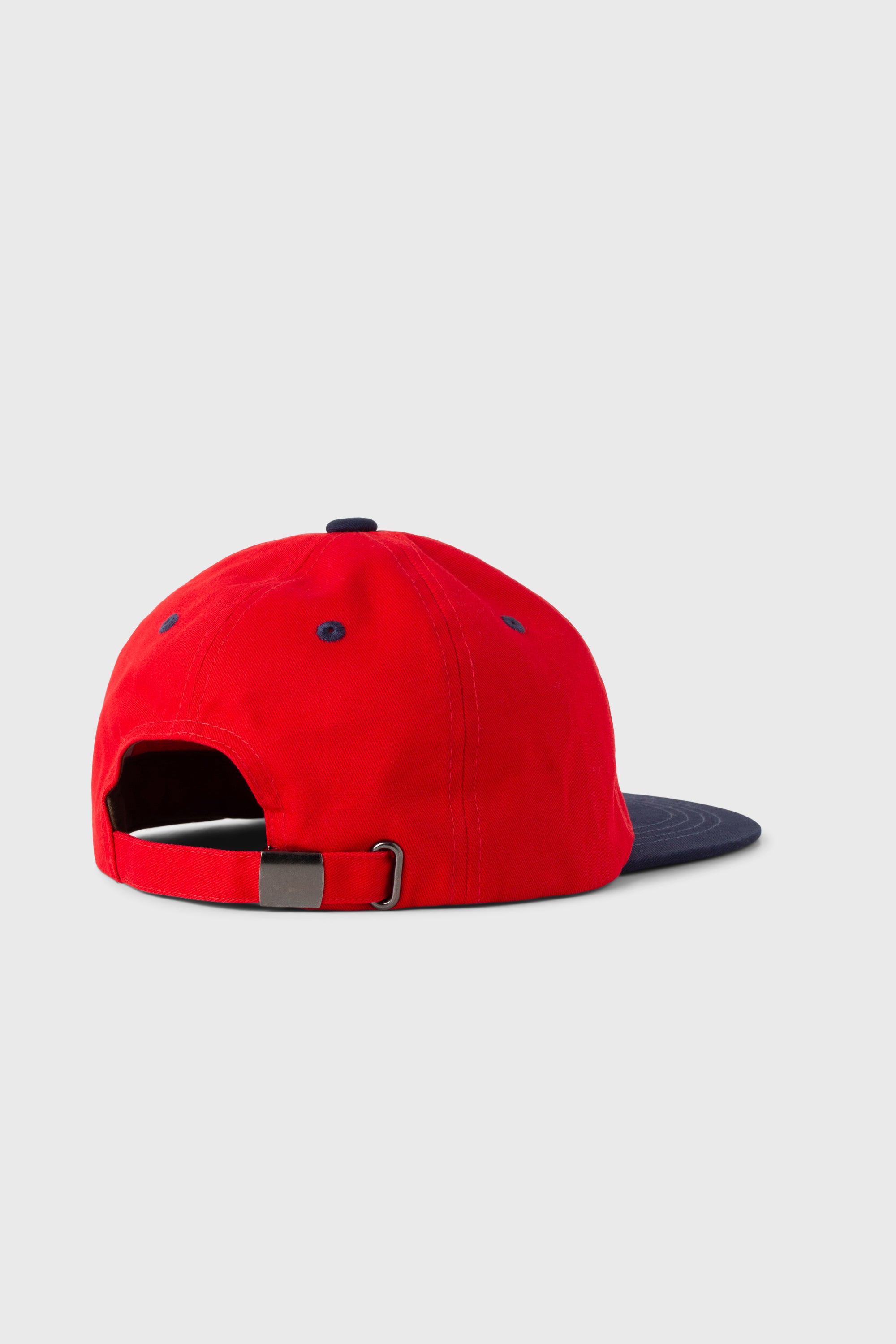 Front view of model wearing Stan Ray Ball Cap Combo red and black cotton twill cap with adjustable leather strap and metal fastener.