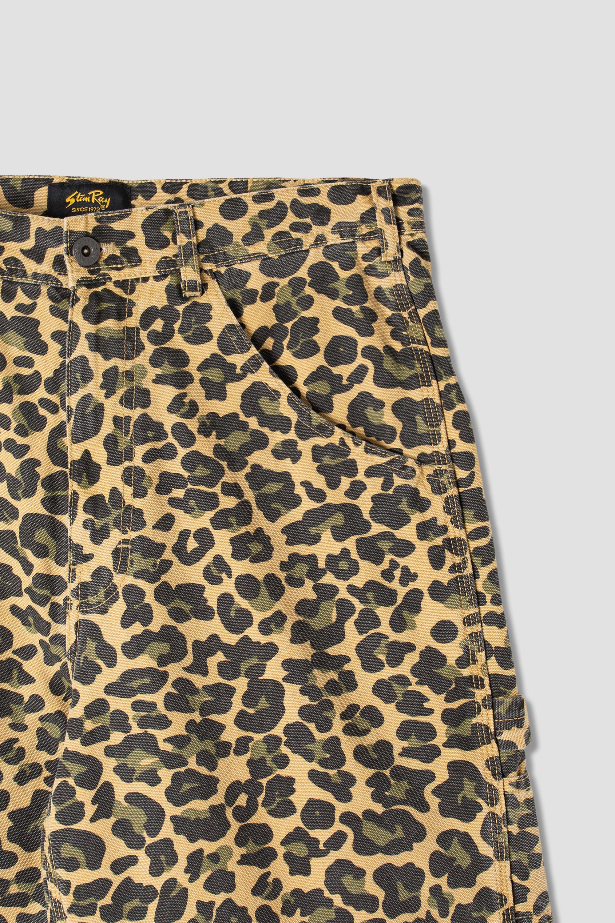 Side view of model wearing Stan Ray Big Job Short Leopard Camo oversized painter shorts with durable cotton twill and relaxed fit.