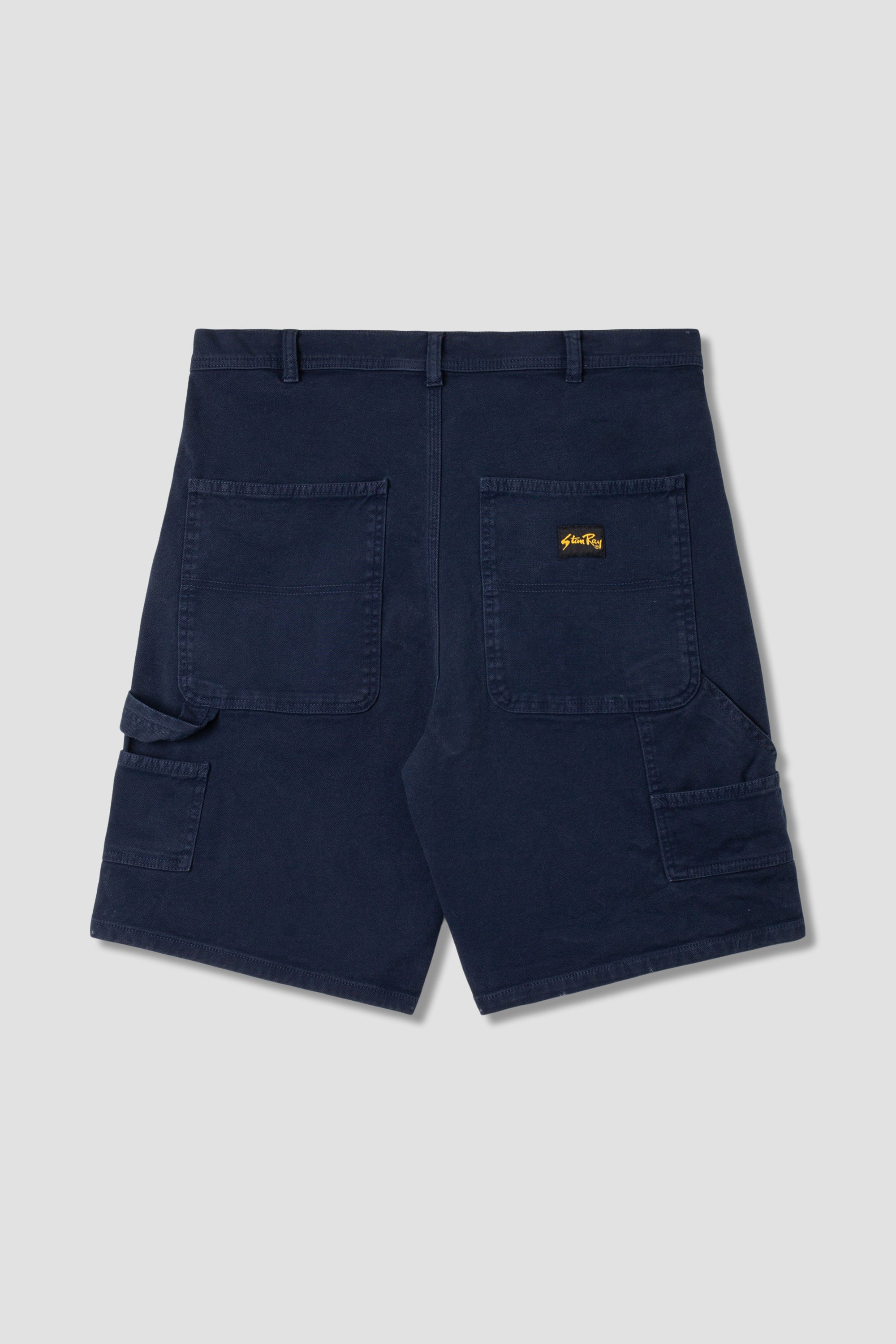 Back view of model wearing Stan Ray Big Job Short Navy Duck oversized painter shorts with utility pockets and relaxed everyday fit.