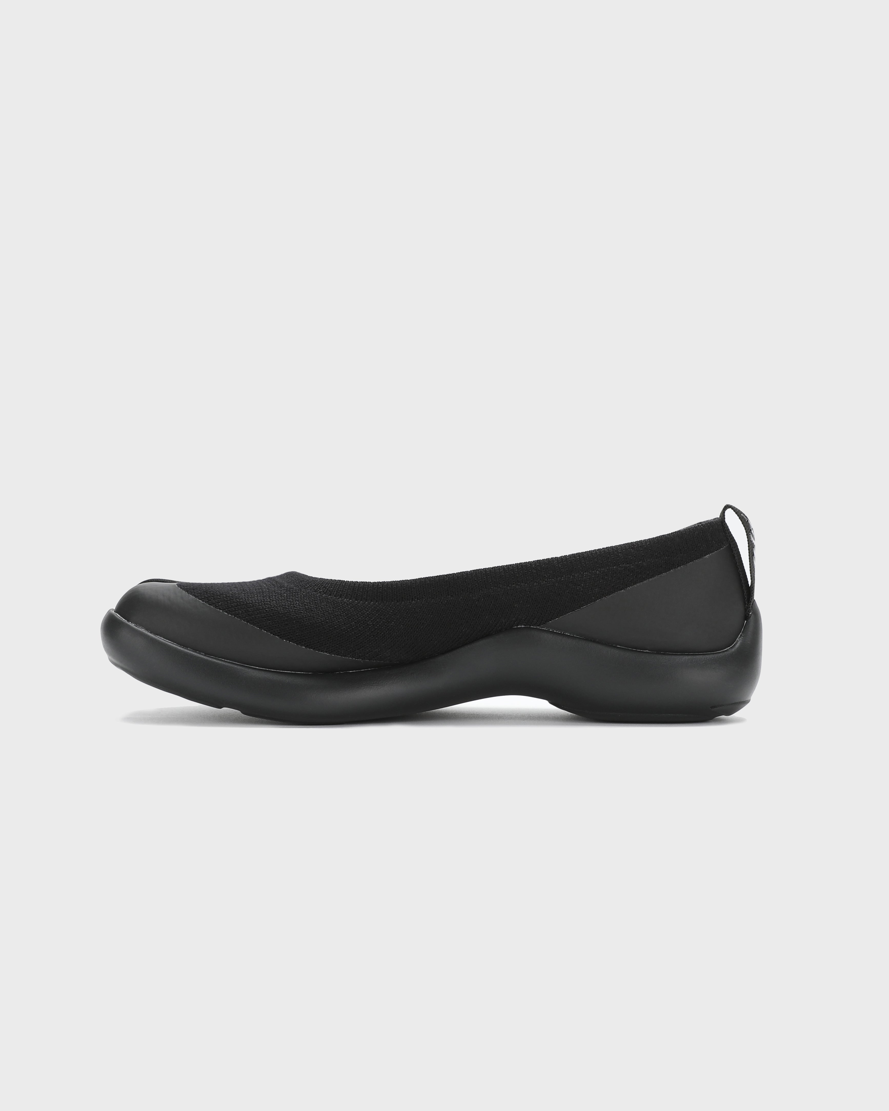 Side view of black Tabi Ballerina shoes featuring a split toe design and lightweight sole