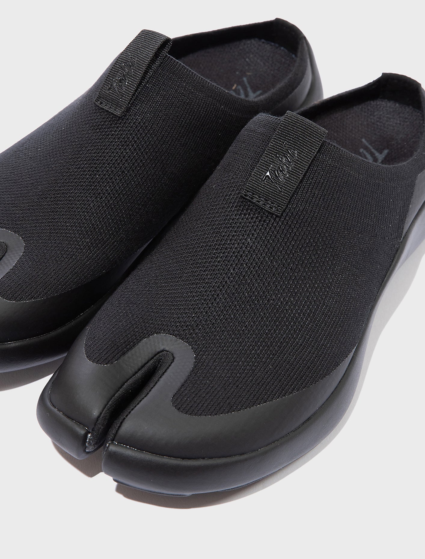 Front close-up of Tabi Mules Black split-toe knit mule shoes with soft tencel upper and cushioned Ortholite insole for comfort.
