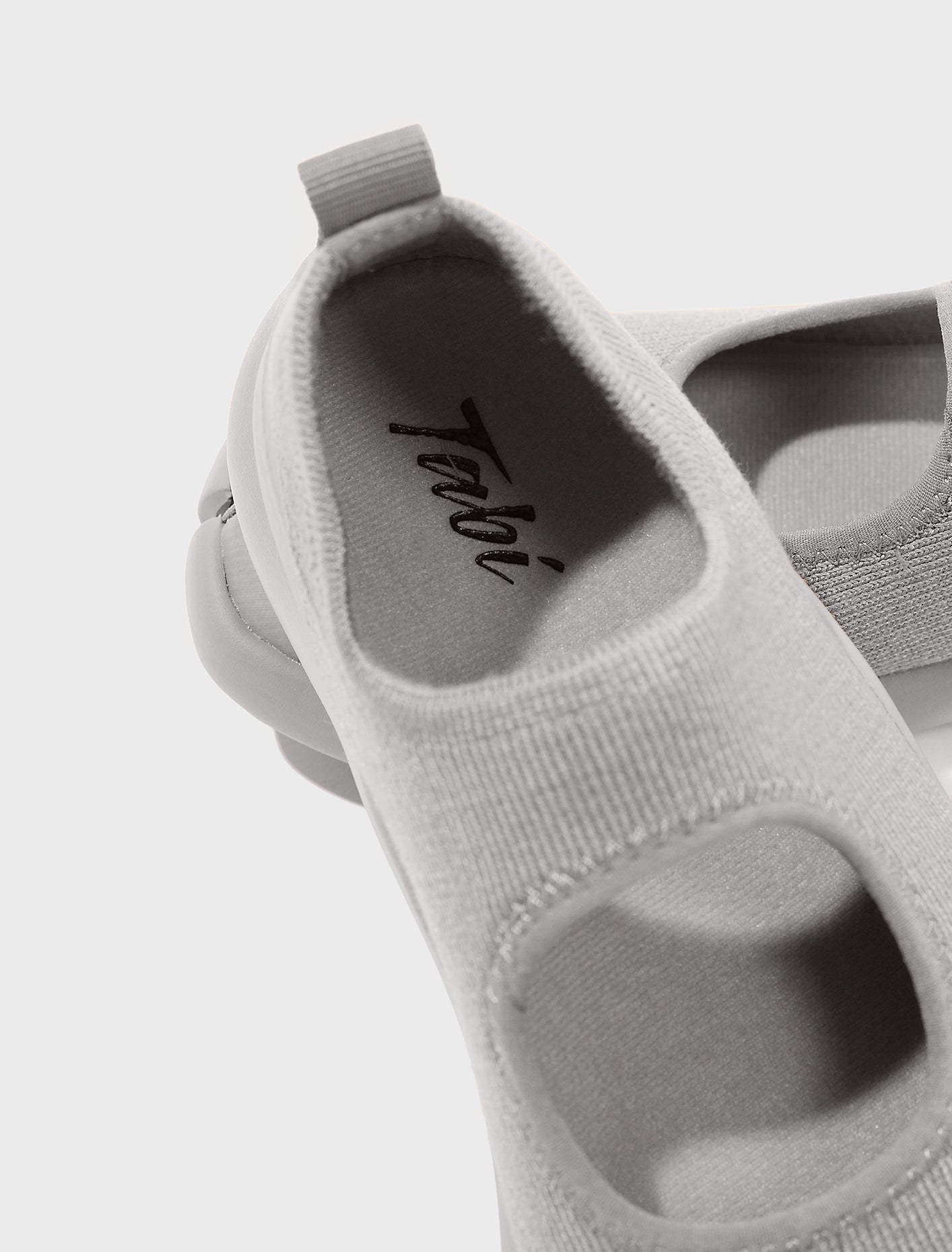 Close-up detail of Tabi Sandal Grey showing logo, split-toe knit upper and lightweight breathable construction.