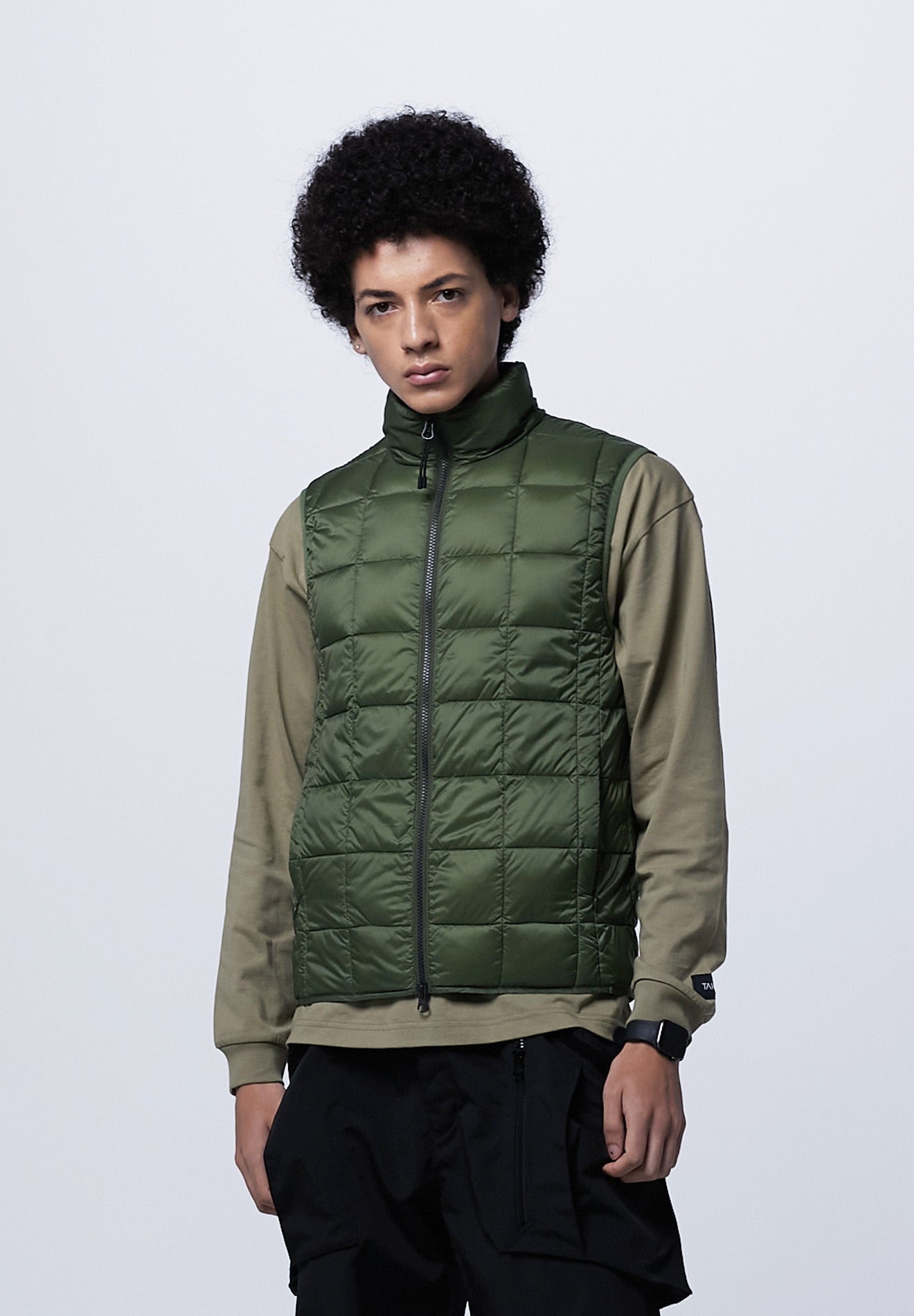 Model wearing Taion Hi Neck W-Zip Down Vest in D.Olive