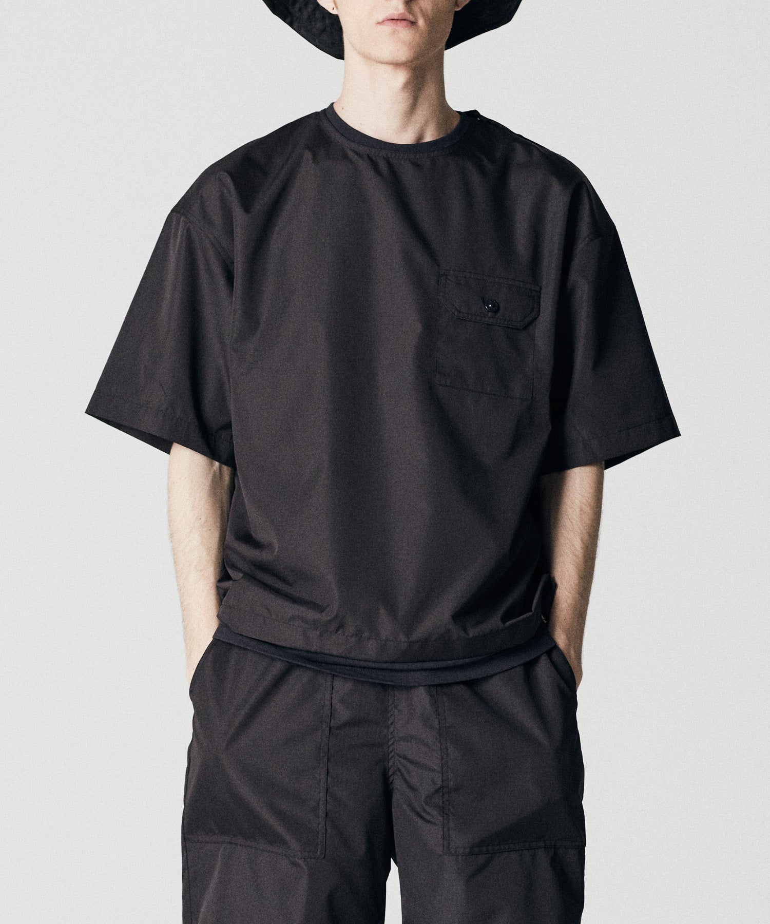 Taion Non Down Military Half Sleeve Cut Sew in Black with lightweight stain-resistant fabric and relaxed everyday comfort