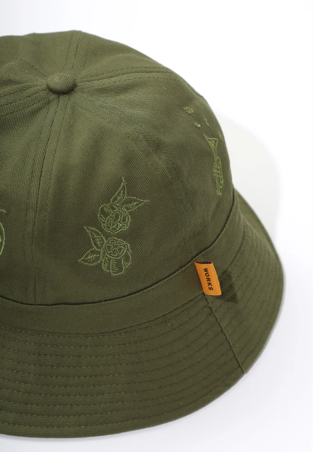 Olive Service Works bucket hat side view with embroidered details and orange woven label