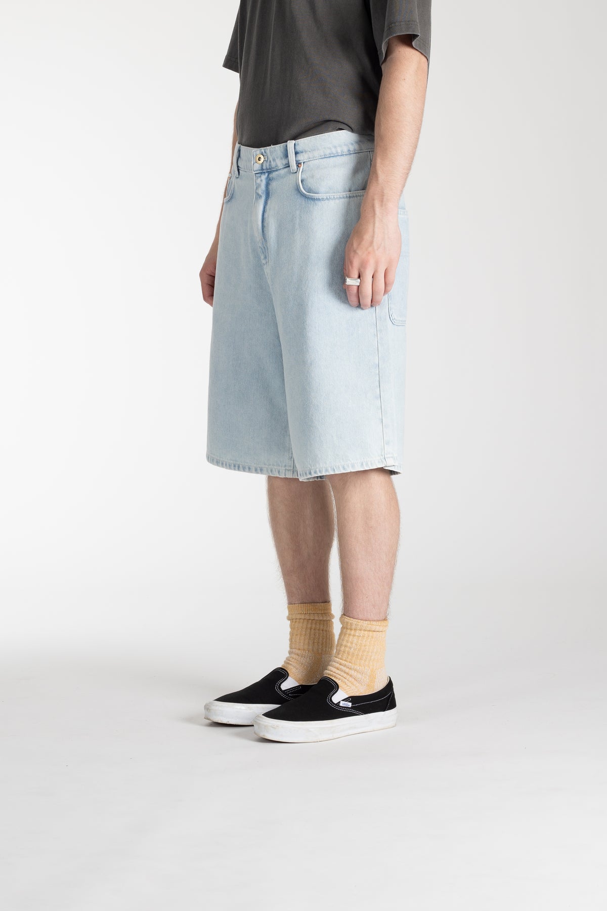 Person wearing Stan Ray Wide 5 Short lite blue denim shorts with grey t-shirt
