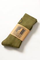 Close-up view of olive green salt and pepper socks showing texture and fabric detail