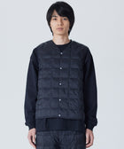 Model wearing TAION Men's V-Neck Button Down Down Vest in Black with lightweight 800 Fill Power insulation