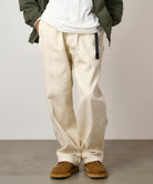 Side view of model wearing bone hemp Gramicci-style straight fit pants with elastic waistband and cinch belt, lightweight durable twill fabric for everyday and streetwear style