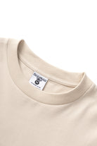 Natural cotton bootleg long sleeve tee front detail modern streetwear design relaxed fit