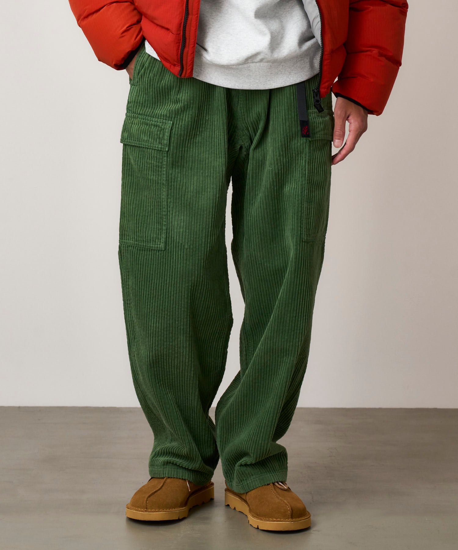 Detail view of Pine Green corduroy cargo pants highlighting fabric texture, relaxed fit and durable utility design for everyday wear