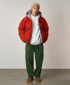Front view of model wearing Pine Green corduroy cargo pants with relaxed fit and utility pocket design for everyday style