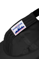 Detail view of black Chefs Kiss Cap highlighting nylon fabric texture, curved peak brim and unstructured streetwear design