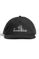Model wearing black Chefs Kiss Cap shown from side angle, featuring nylon fabric, curved peak brim and relaxed streetwear low profile silhouette