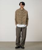 Front view of model wearing beige corduroy trucker jacket with workwear pockets, classic silhouette and durable cotton corduroy construction