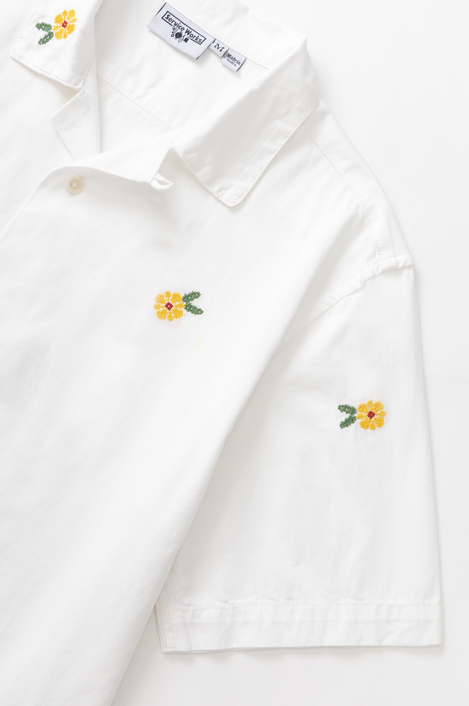 White cross stitch shirt front detail premium cotton urban streetwear design close up