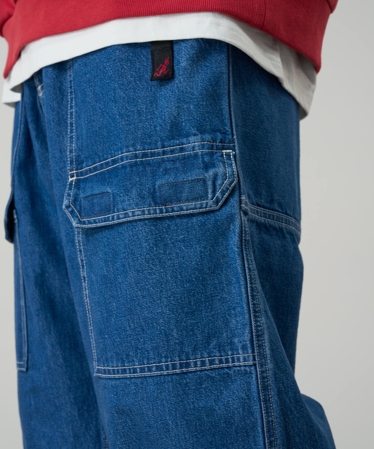 Side view of model wearing Denim EQT Pant in Light Wash