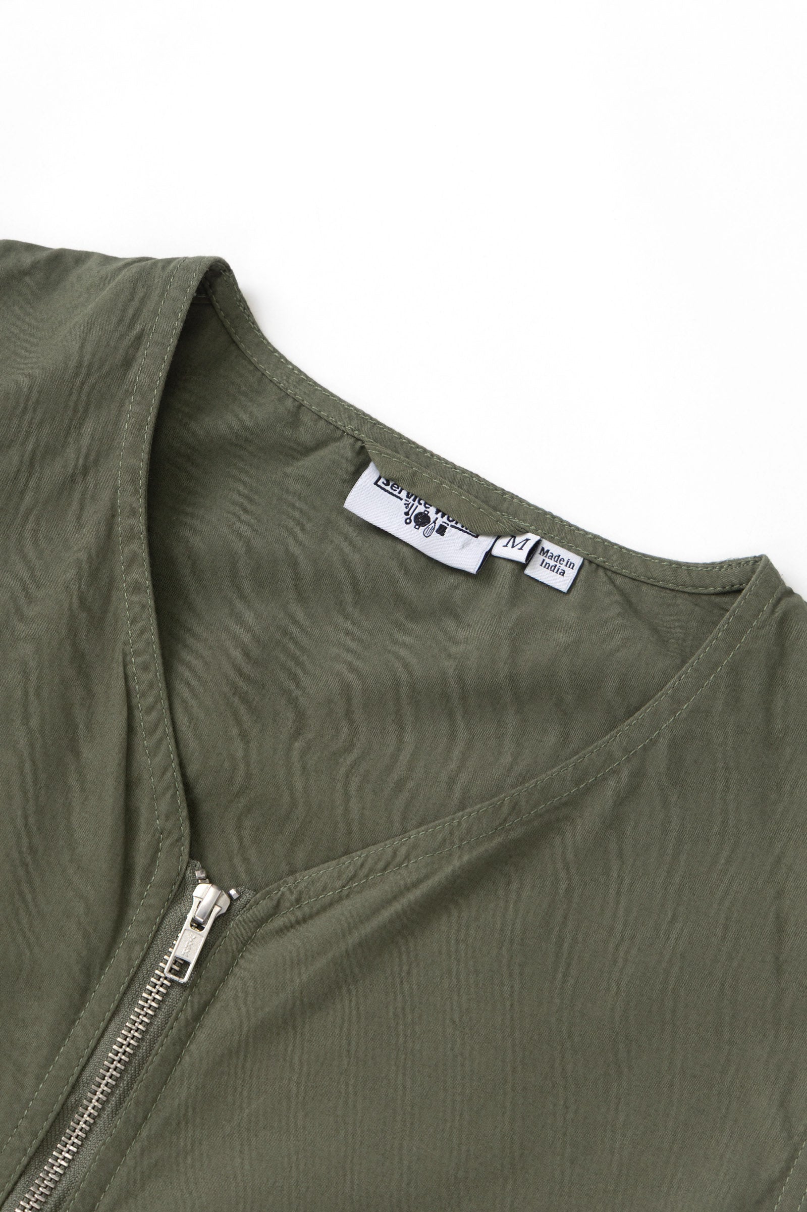 Olive utility vest pocket detail in organic cotton with YKK hardware