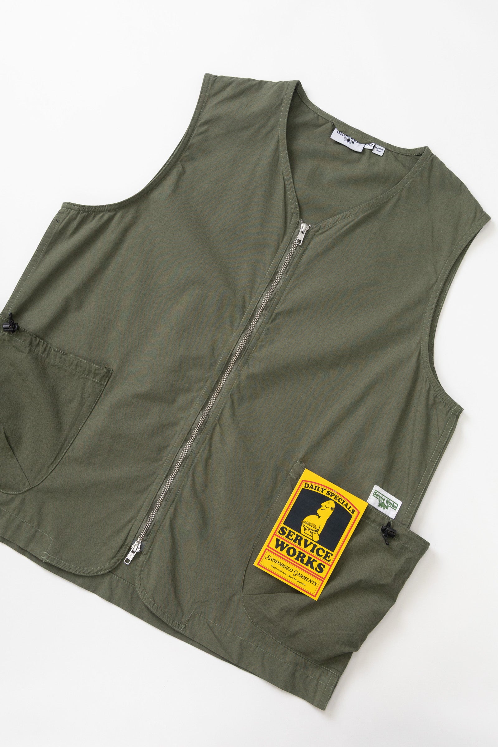Olive organic cotton utility vest side view with pockets