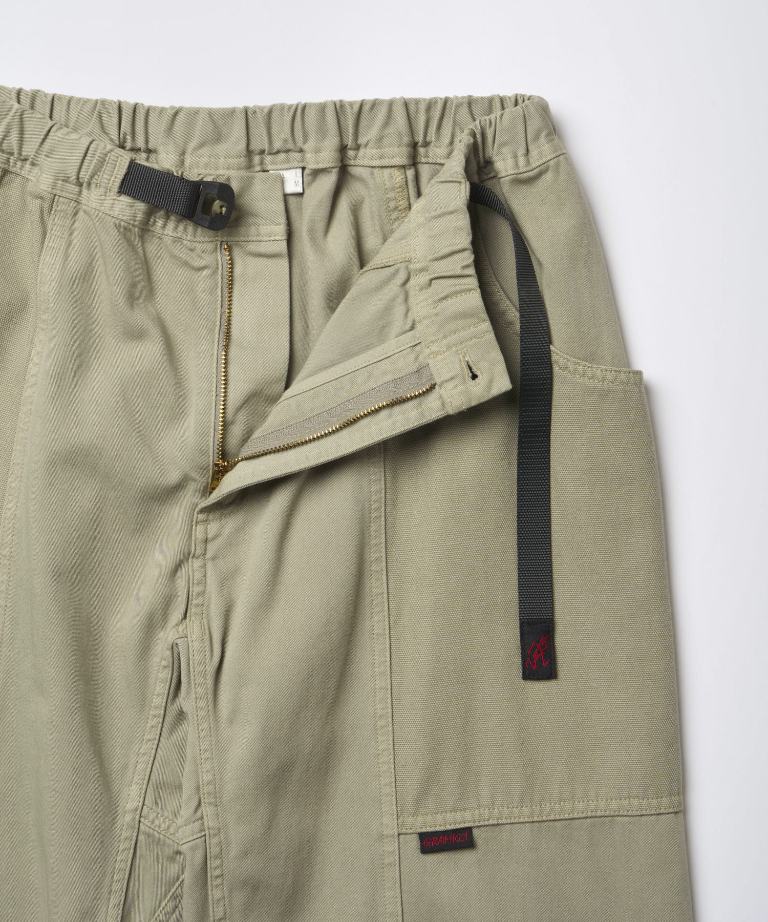 Close-up of Gramicci Gadget Pant Dried Sage featuring the integrated webbing belt and durable cotton twill fabric
