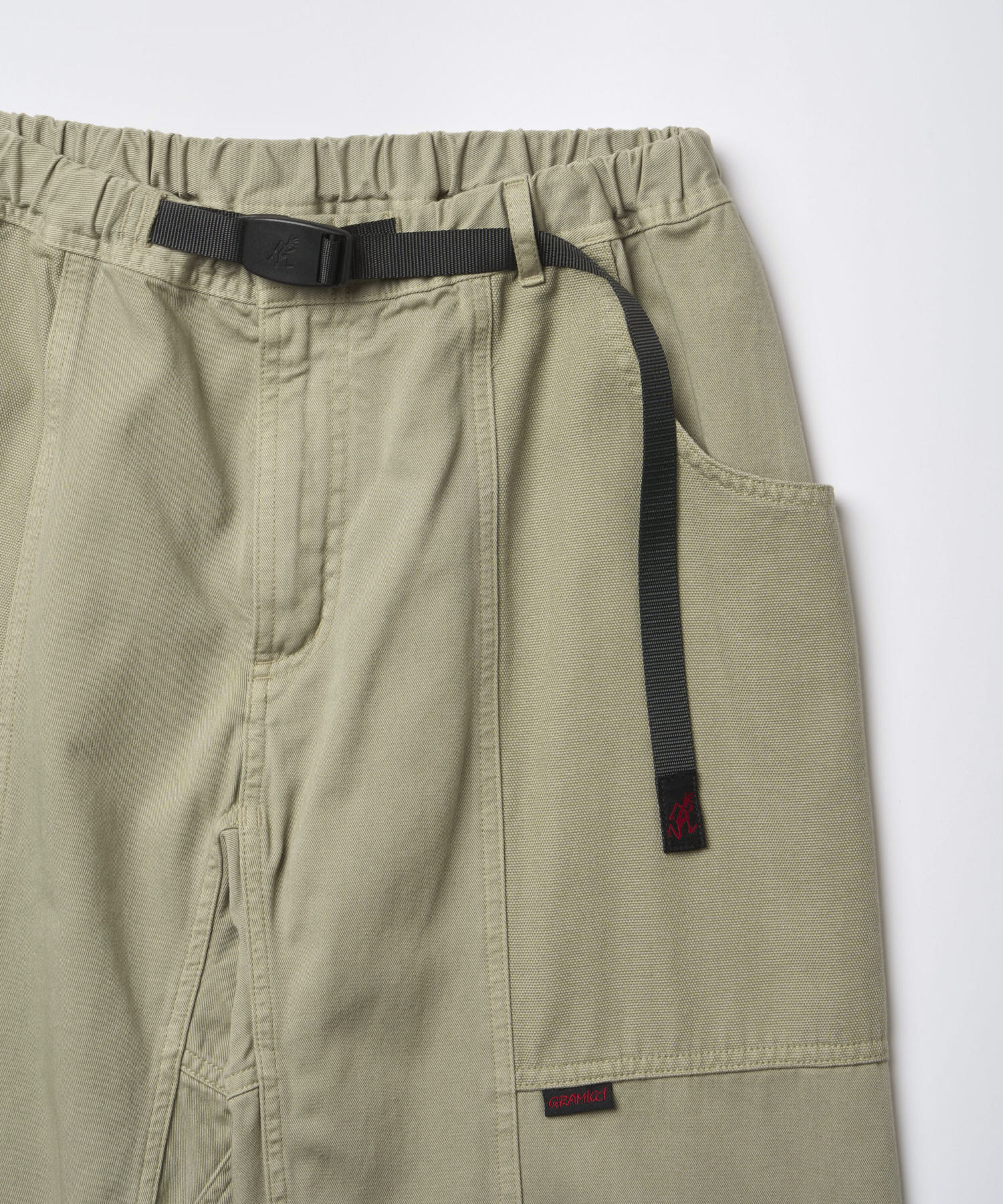 Close-up of Gramicci Gadget Pant Dried Sage showing utility pockets and durable cotton twill fabric