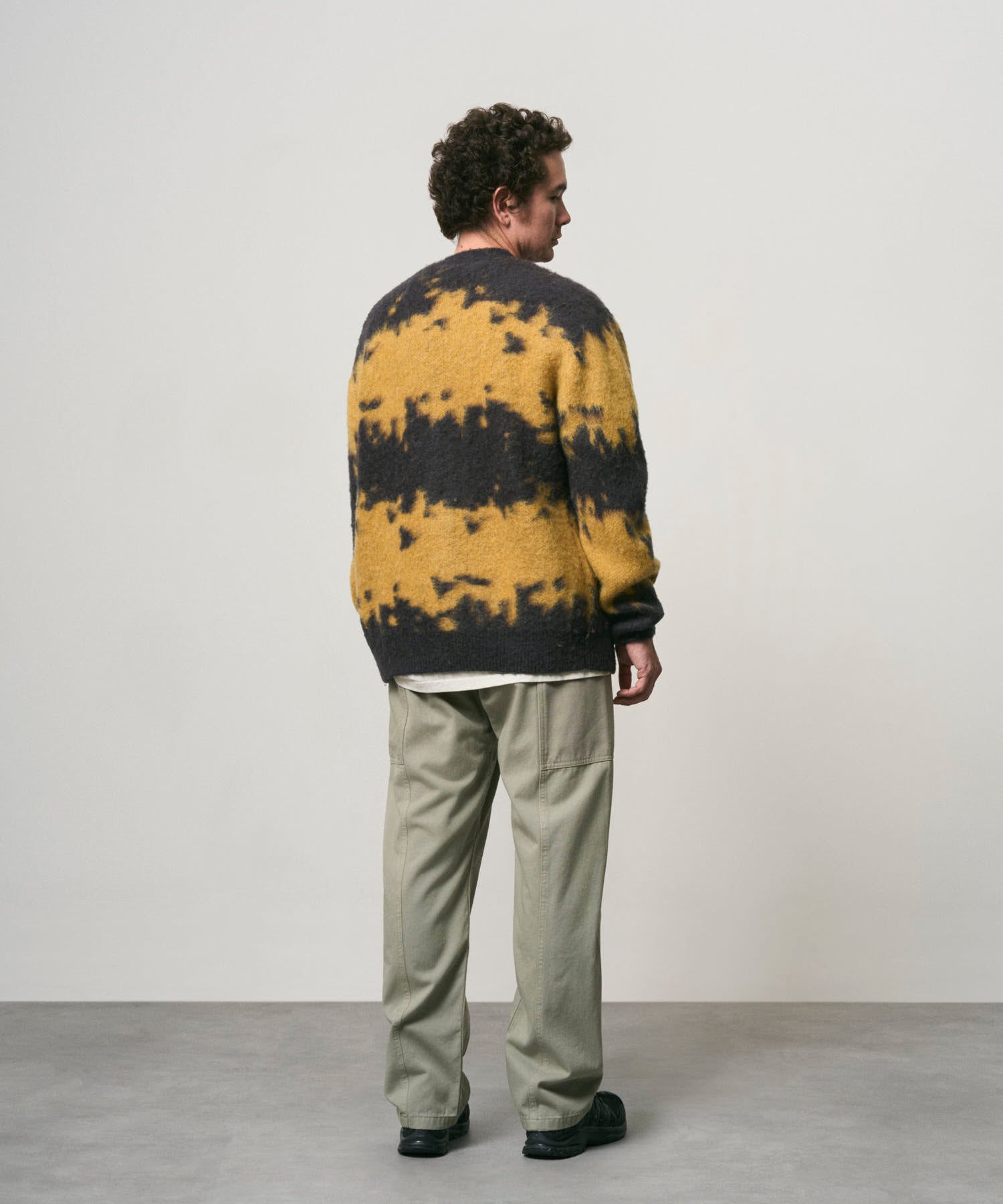 Side view of male model wearing Gramicci Gadget Pant Dried Sage utility pants