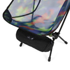 Angled detail view of Gramicci & Helinox Chair One in camo showing lightweight frame and tie-dyed mesh fabric construction